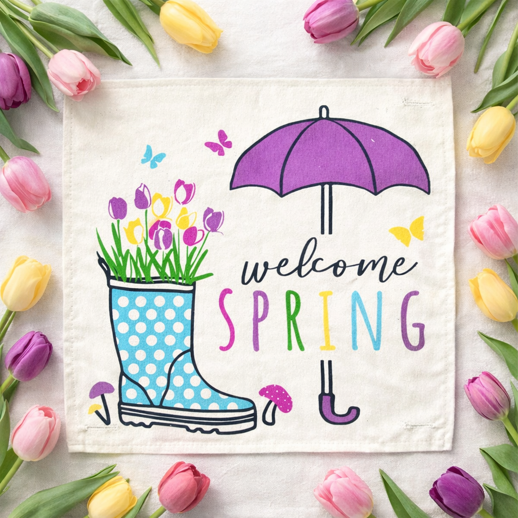 Decorative towel with 'Welcome Spring' text, rain boot, umbrella, and flowers on a white background with tulips around.
