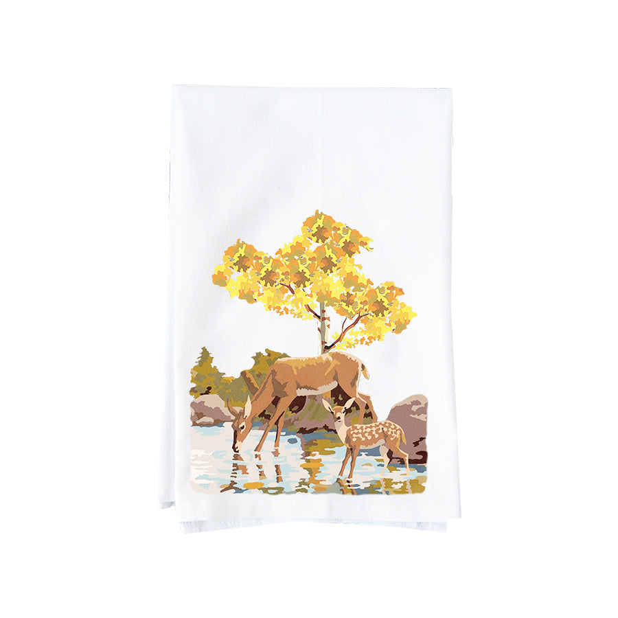 Tea towel with a design of two deer by a tree on a white background