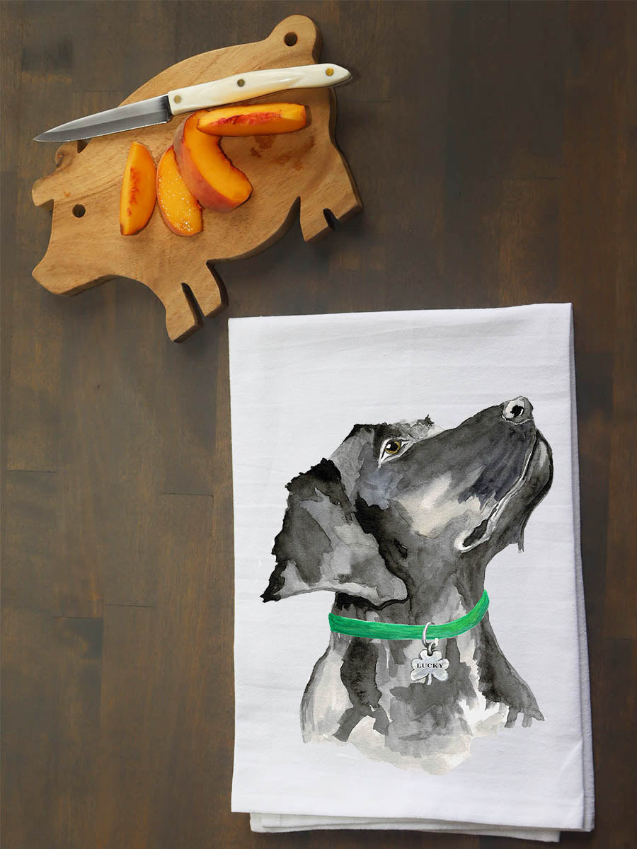 Tea towel with a dog illustration on a wooden surface with a cutting board and knife.