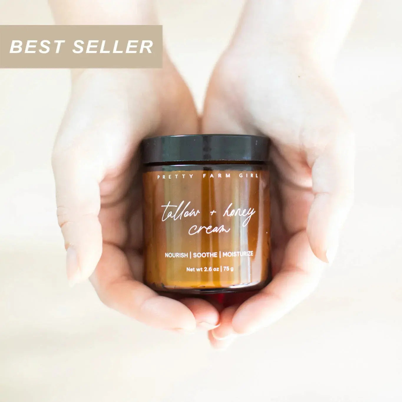 Hands holding Pretty Farm Girl tallow + honey cream jar, best seller nourish soothe moisturize