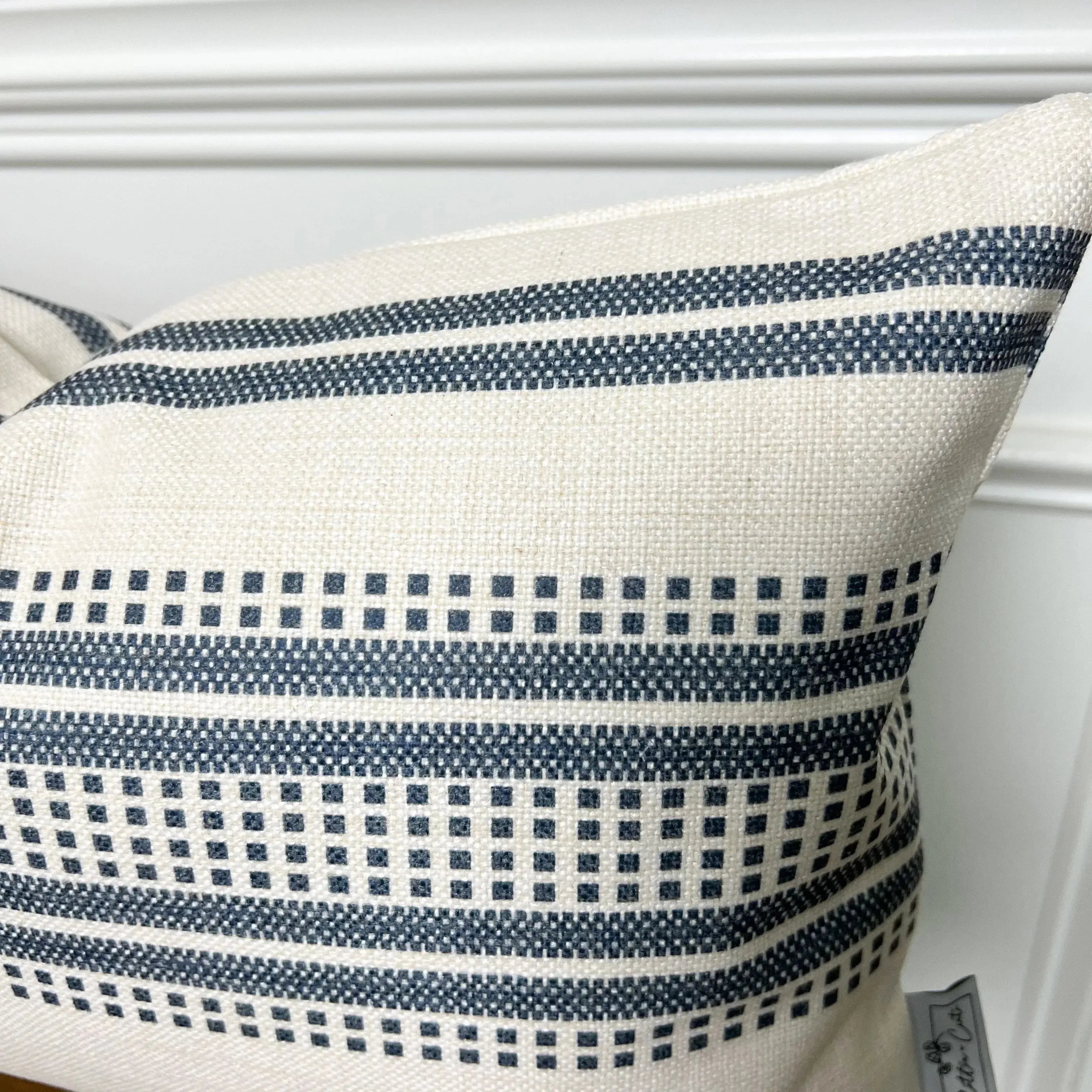 Cream throw pillow with navy blue geometric stripes, farmhouse style decor