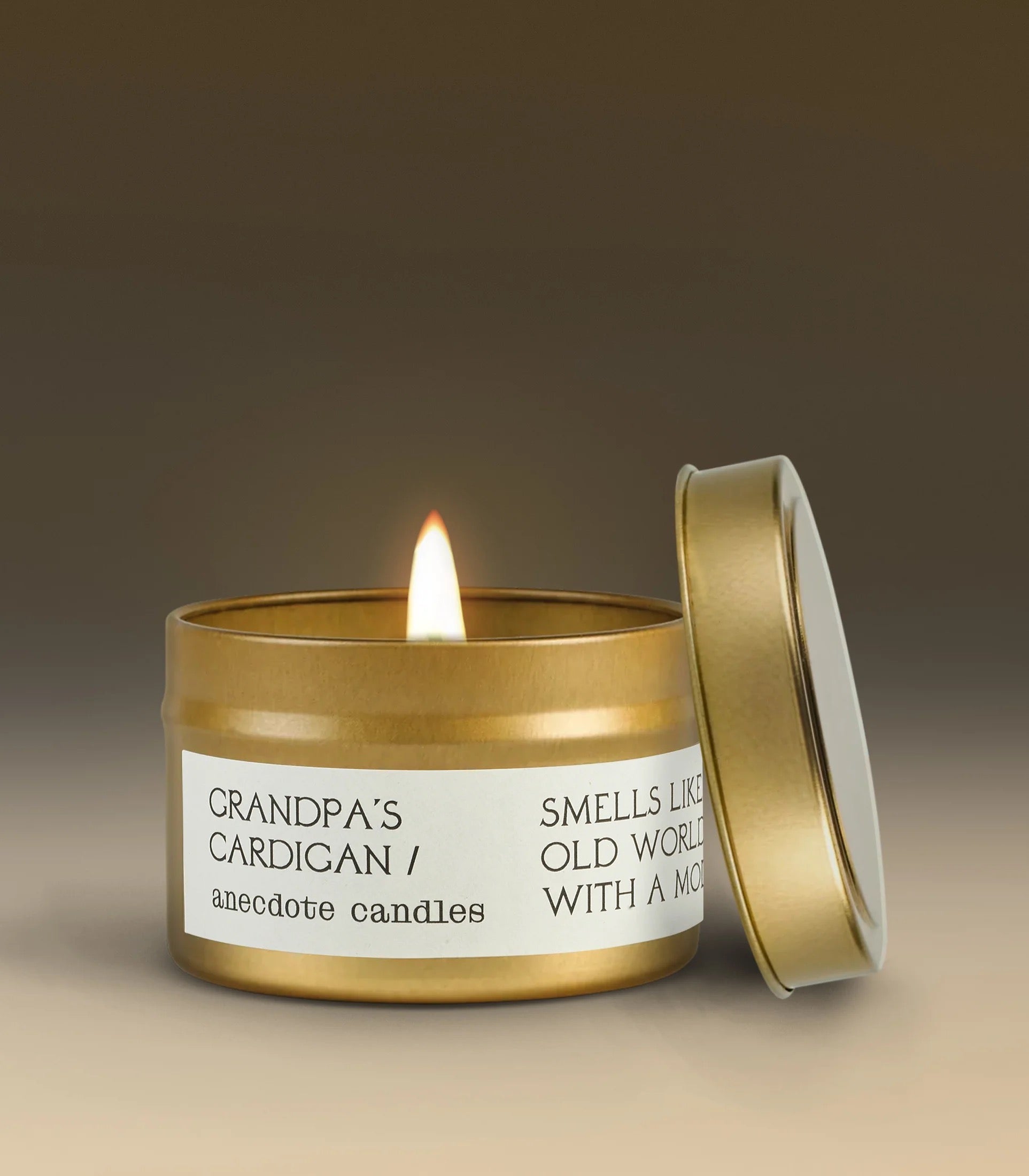 Candle in a gold tin with a label on a gradient background
