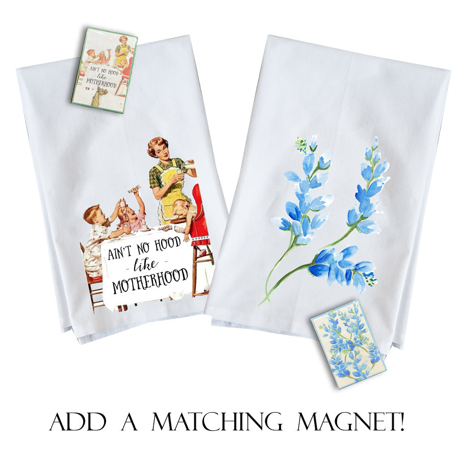 Two white towels with printed designs and a matching magnet on a white background.