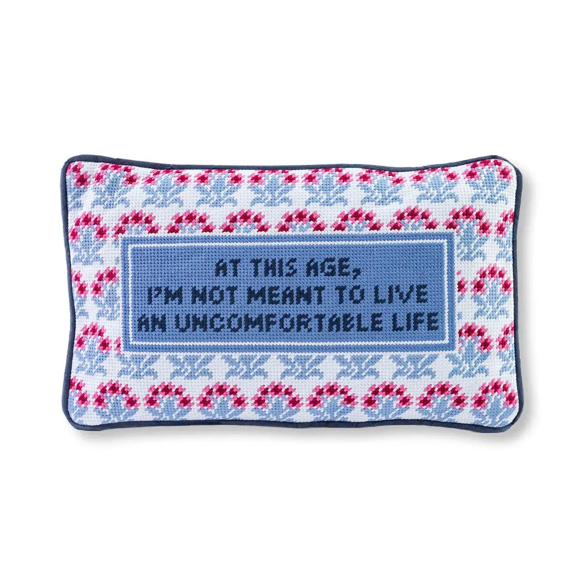 Cozy needlepoint pillow with floral border and quote: 'At this age, I'm not meant to live an uncomfortable life'