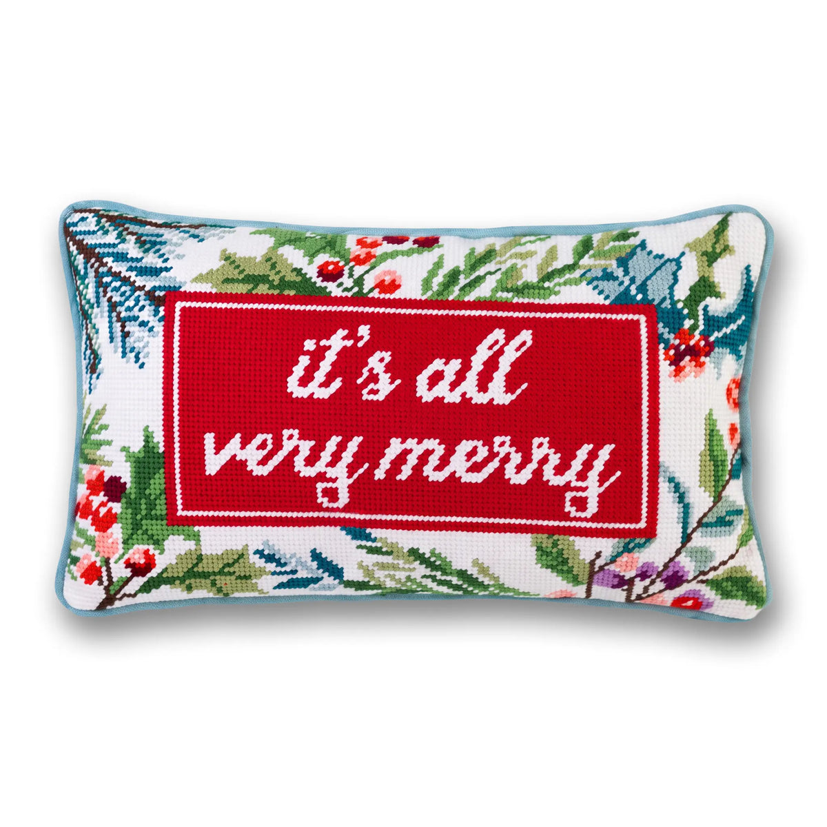 A rectangular cross-stitch pillow featuring a red central panel with the white embroidered text 'it's all very merry' surrounded by a festive green, red, and blue floral border on a white background.