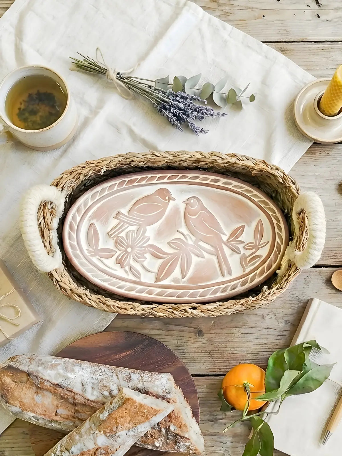 Farmhouse ceramic tray with bird design in woven basket, cozy cottage decor with bread, tea, and lavender