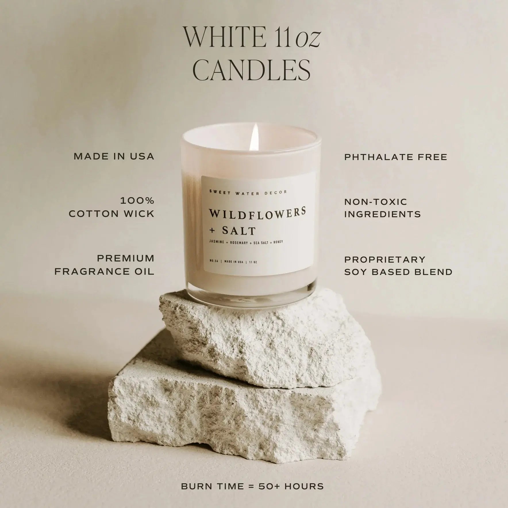 White 11oz Wildflowers + Salt soy candle with cotton wick, non-toxic, made in USA, on rustic stone base