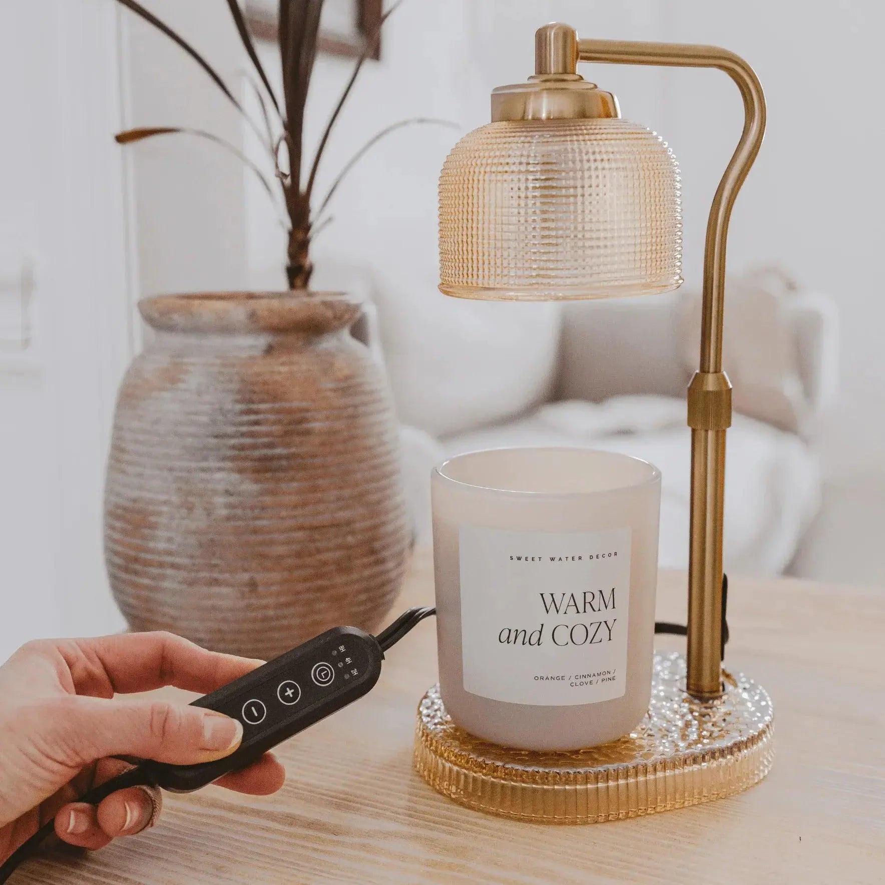 Warm and Cozy scented candle with remote control under brass lamp, farmhouse decor