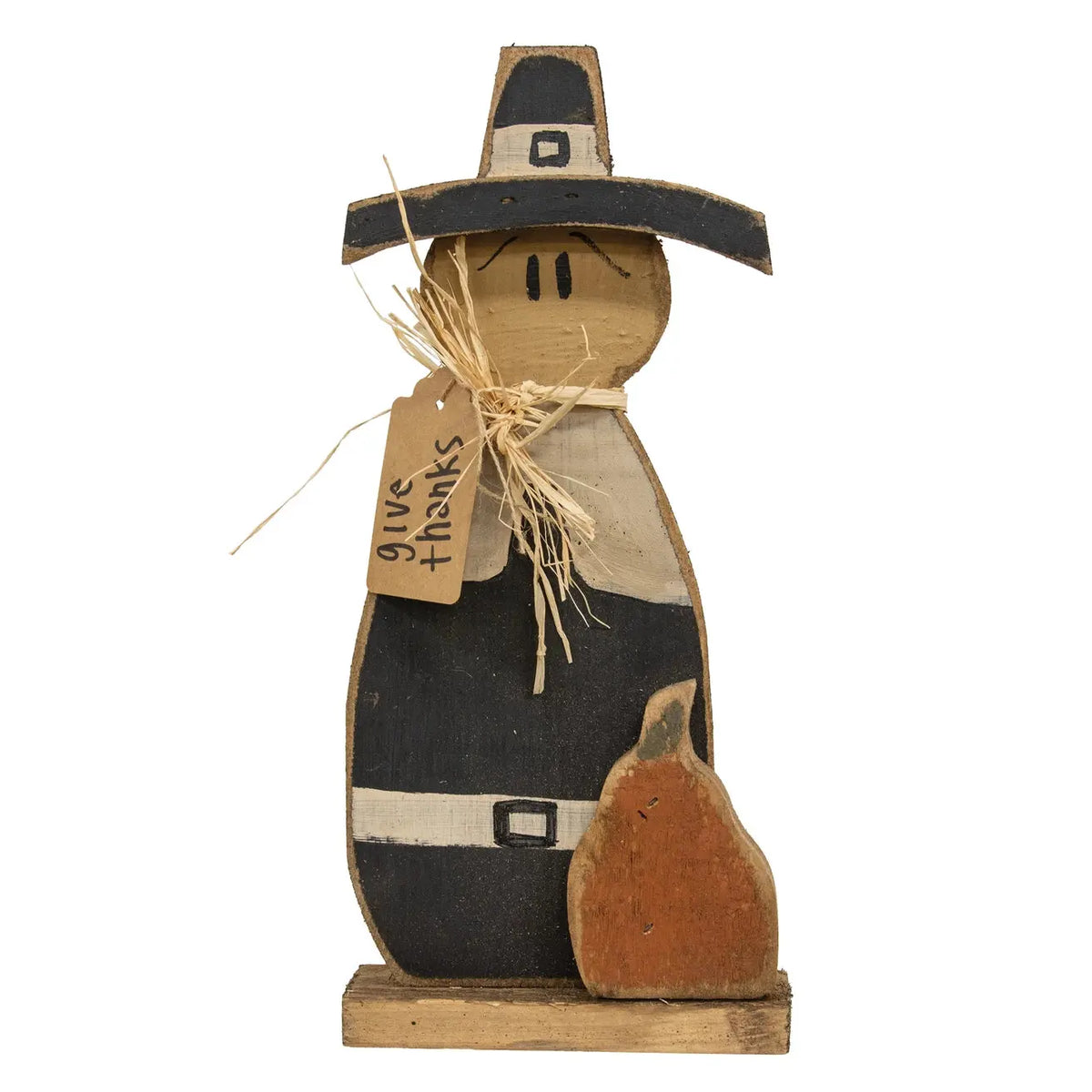 A rustic wooden Thanksgiving-themed decorative figure shaped like a pilgrim with a black hat, tan face and clothing, a small brown pumpkin at its side, and a hanging tag that reads 'give thanks,' shown on a plain white background.