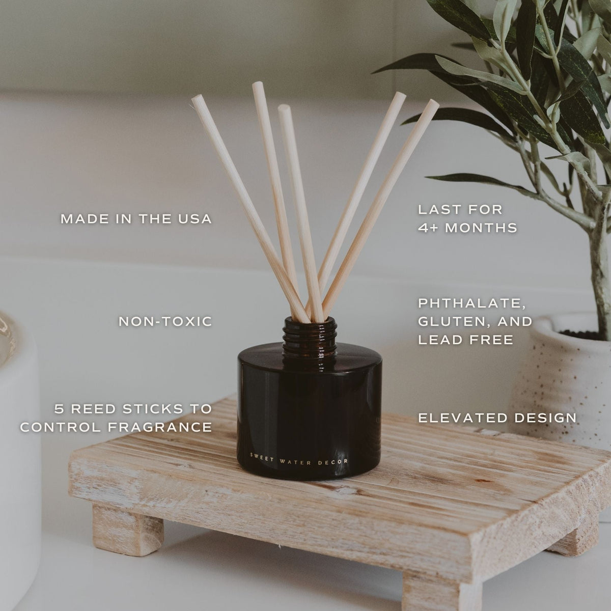 Black reed diffuser with wooden sticks on a wooden stand, featuring text about product features.