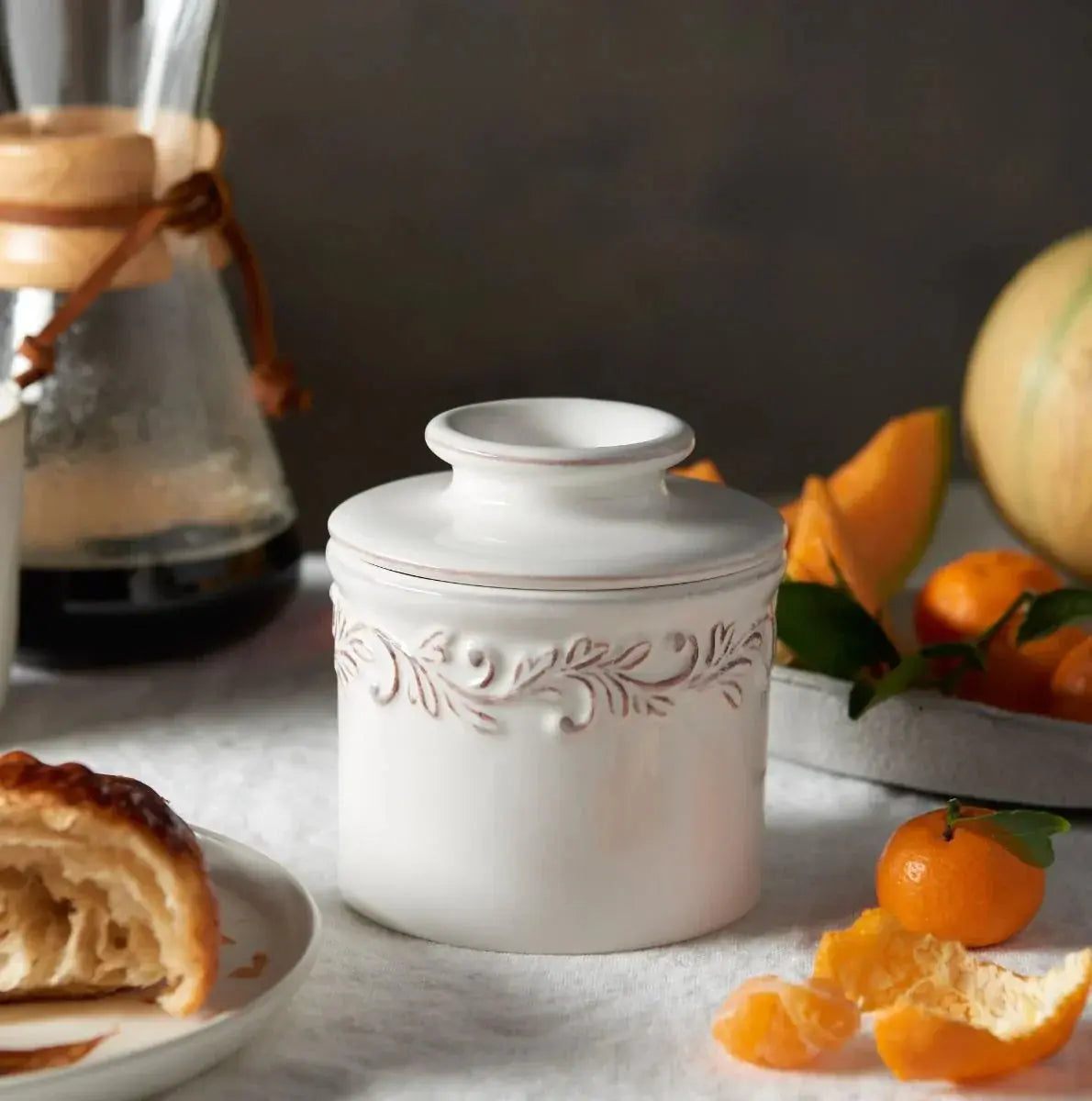 White ceramic canister with floral embossing, farmhouse kitchen decor, cozy cottage style