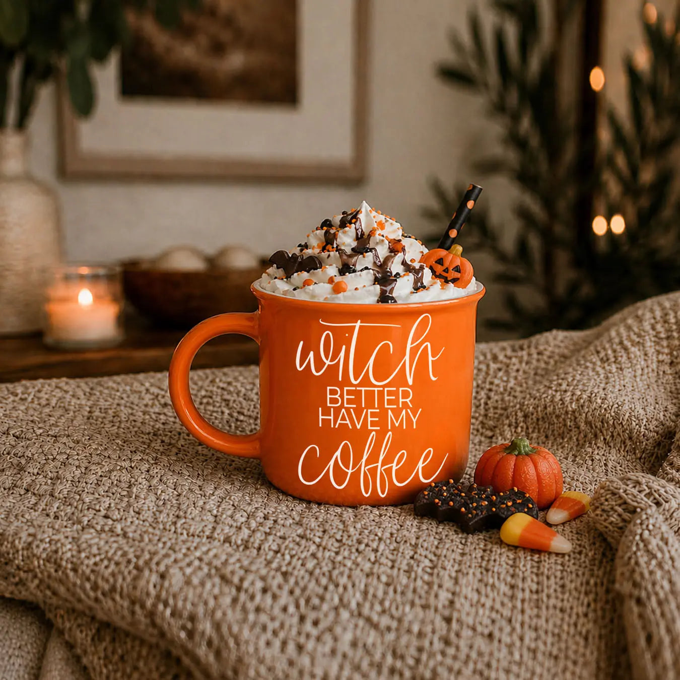 Orange mug with pumpkin spice text, topped with whipped cream and Halloween-themed decorations, on a textured surface.