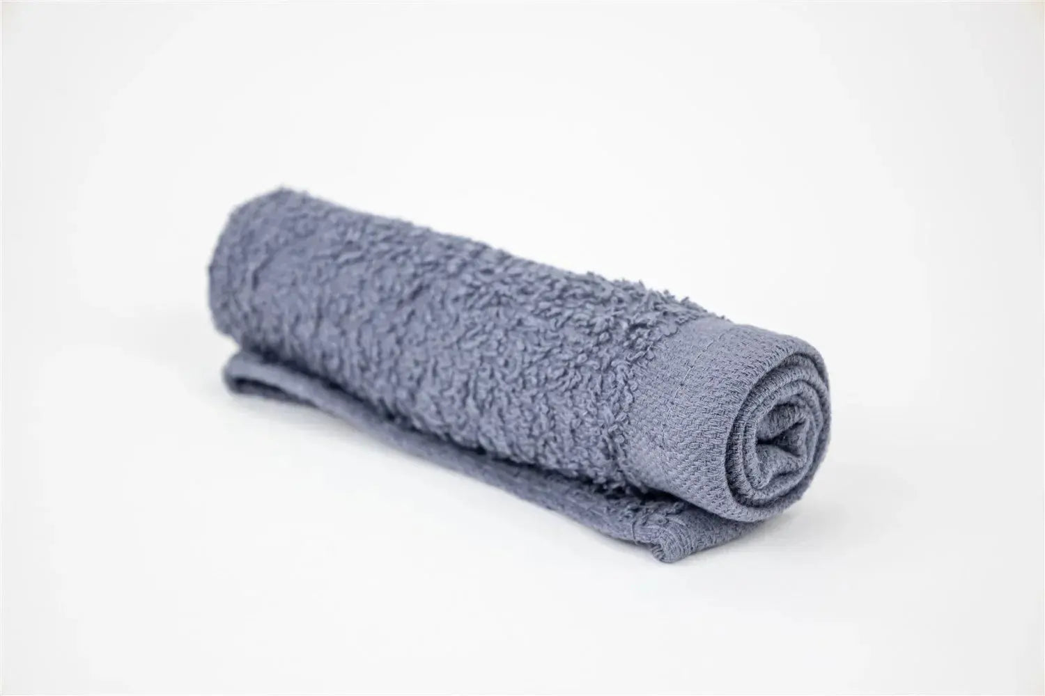 Soft gray bath towel rolled up, cozy farmhouse bathroom essential for warm, peaceful home decor