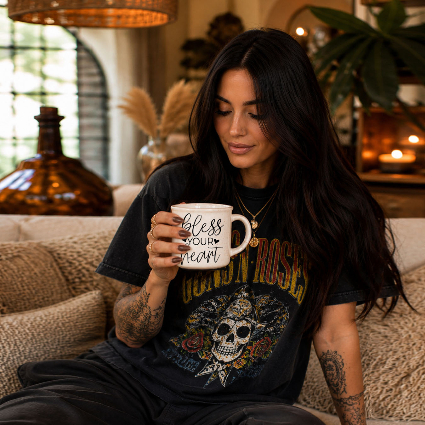 Woman holding a mug with text, sitting on a couch in a cozy room.
