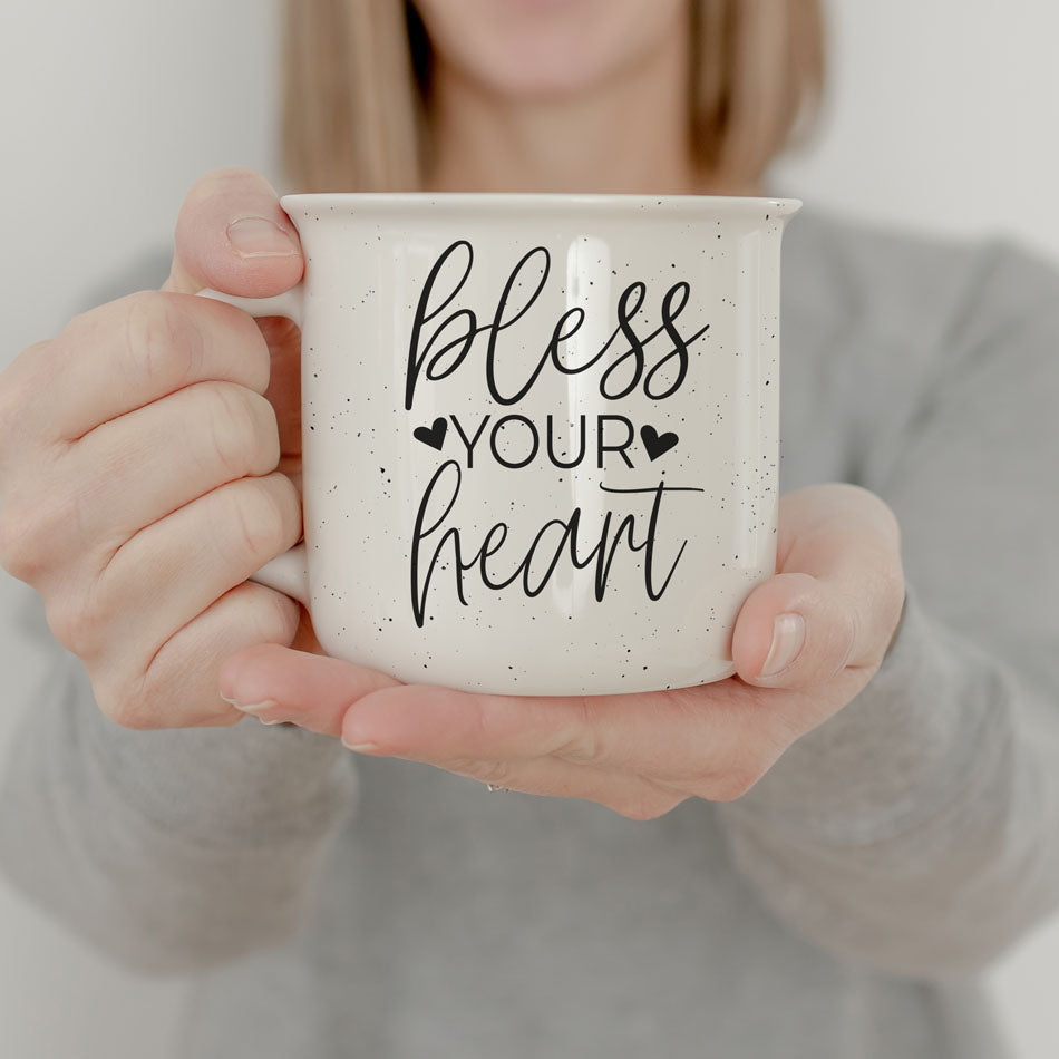 Person holding a mug with 'bless your heart' text