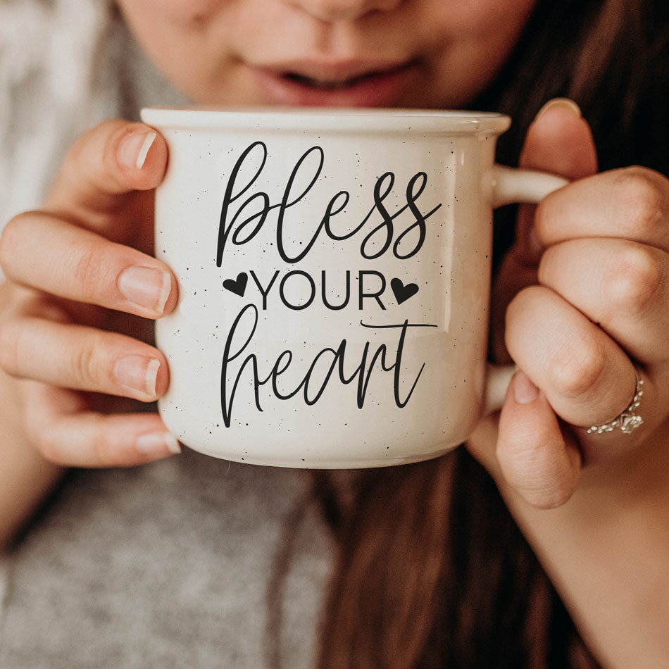 Person holding a mug with 'bless your heart' text