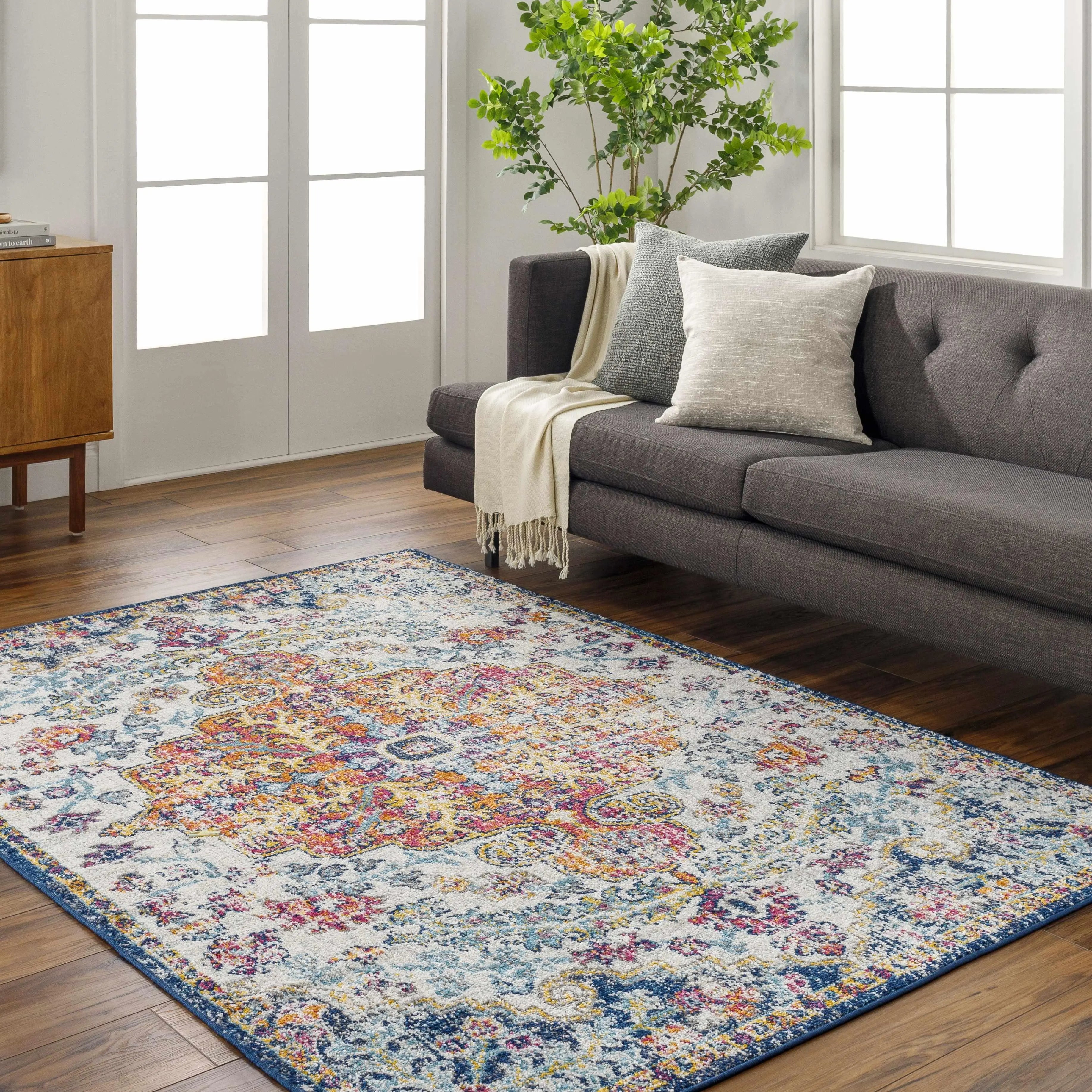 Colorful boho area rug with floral pattern in cozy living room, perfect for farmhouse or cottage decor