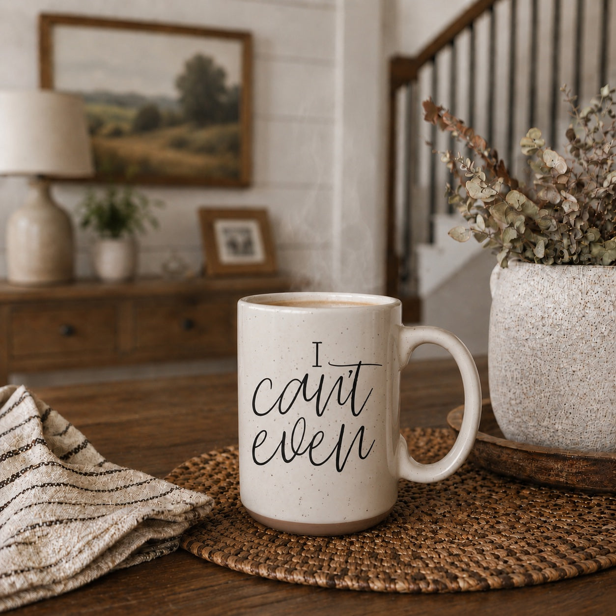 Mug with 'I can't even' text on a table in a home setting