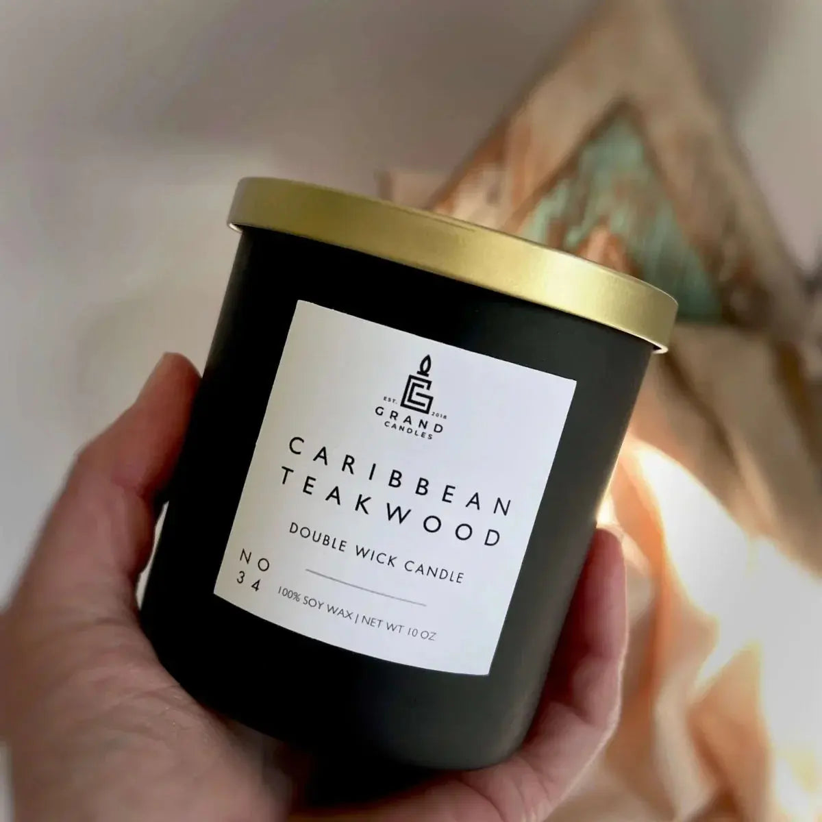 Caribbean Teakwood double wick soy candle in matte black jar with gold lid, cozy home decor