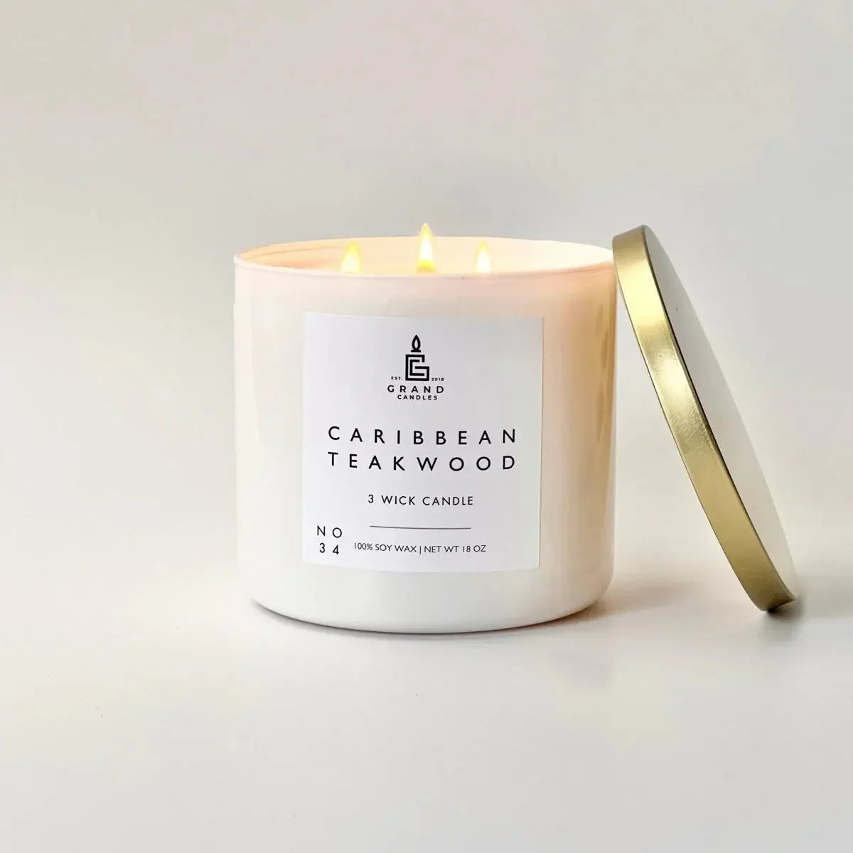 Caribbean Teakwood 3-wick soy candle in white jar with gold lid, cozy home decor