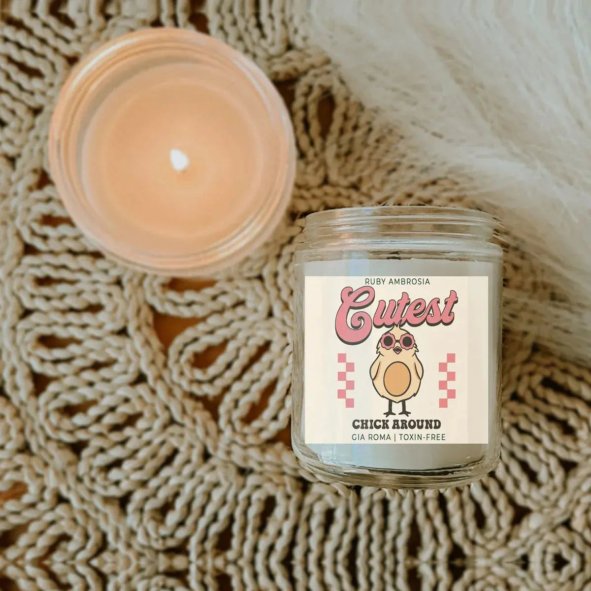 Candle jar with a label on a textured surface