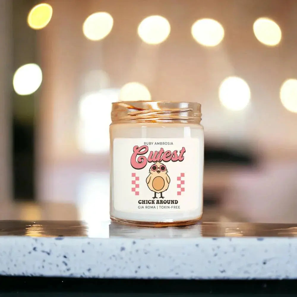 Candle with a cute design on a speckled countertop with blurred lights in the background