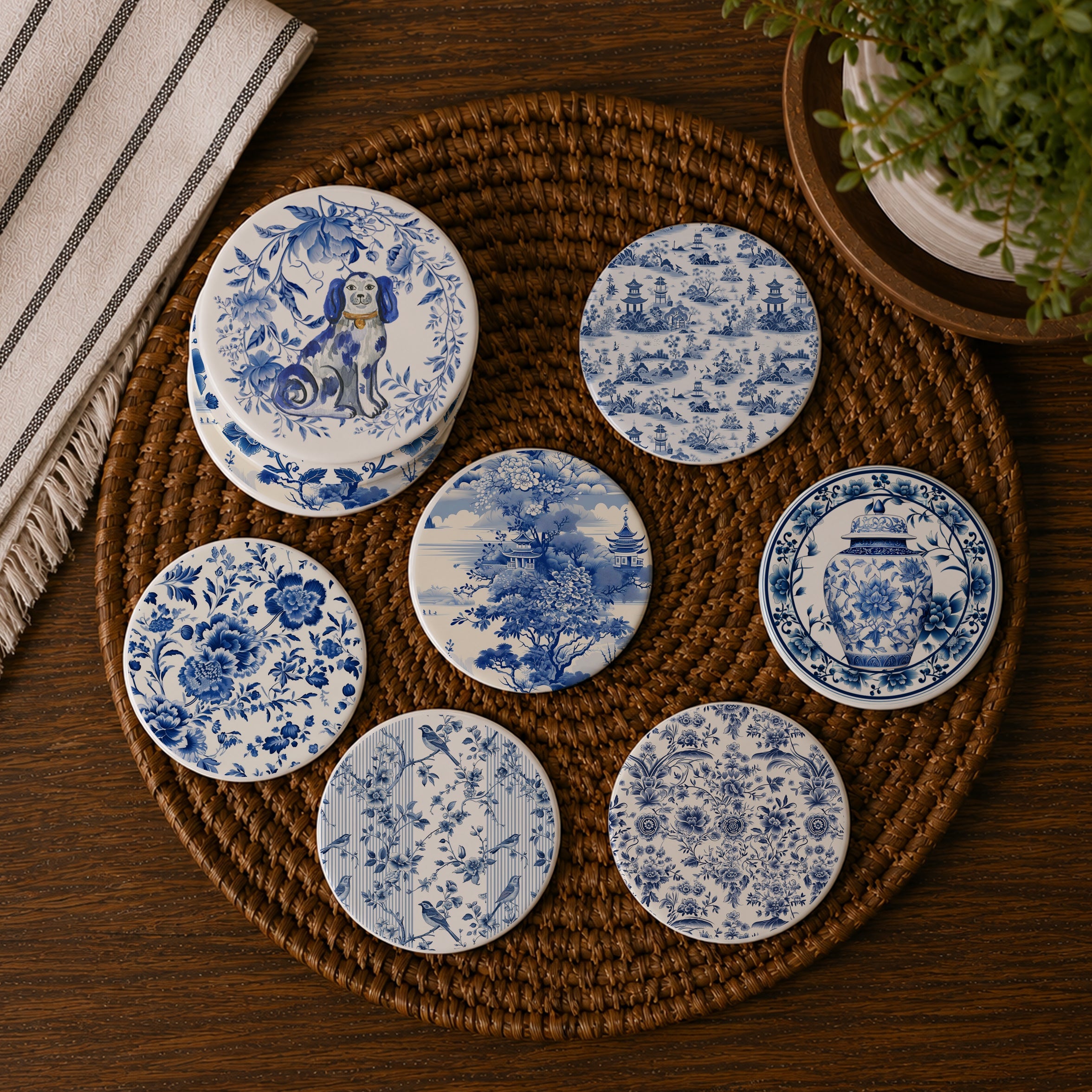 Set of blue and white patterned coasters on a woven mat with a plant and towel in the background.
