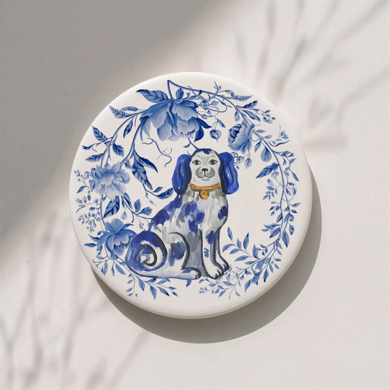 Decorative coaster with a blue and white dog illustration and floral design on a light background