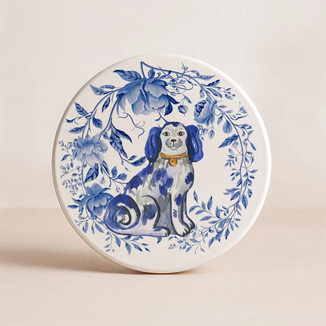 Decorative coaster with a blue and white dog illustration and floral patterns on a beige background