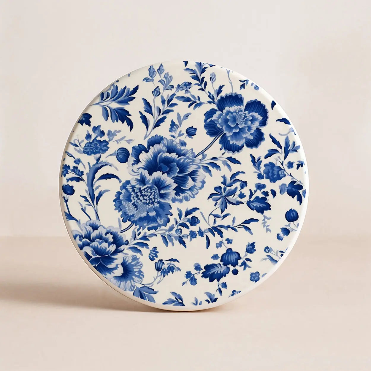 Ceramic coaster with blue floral pattern on a beige background