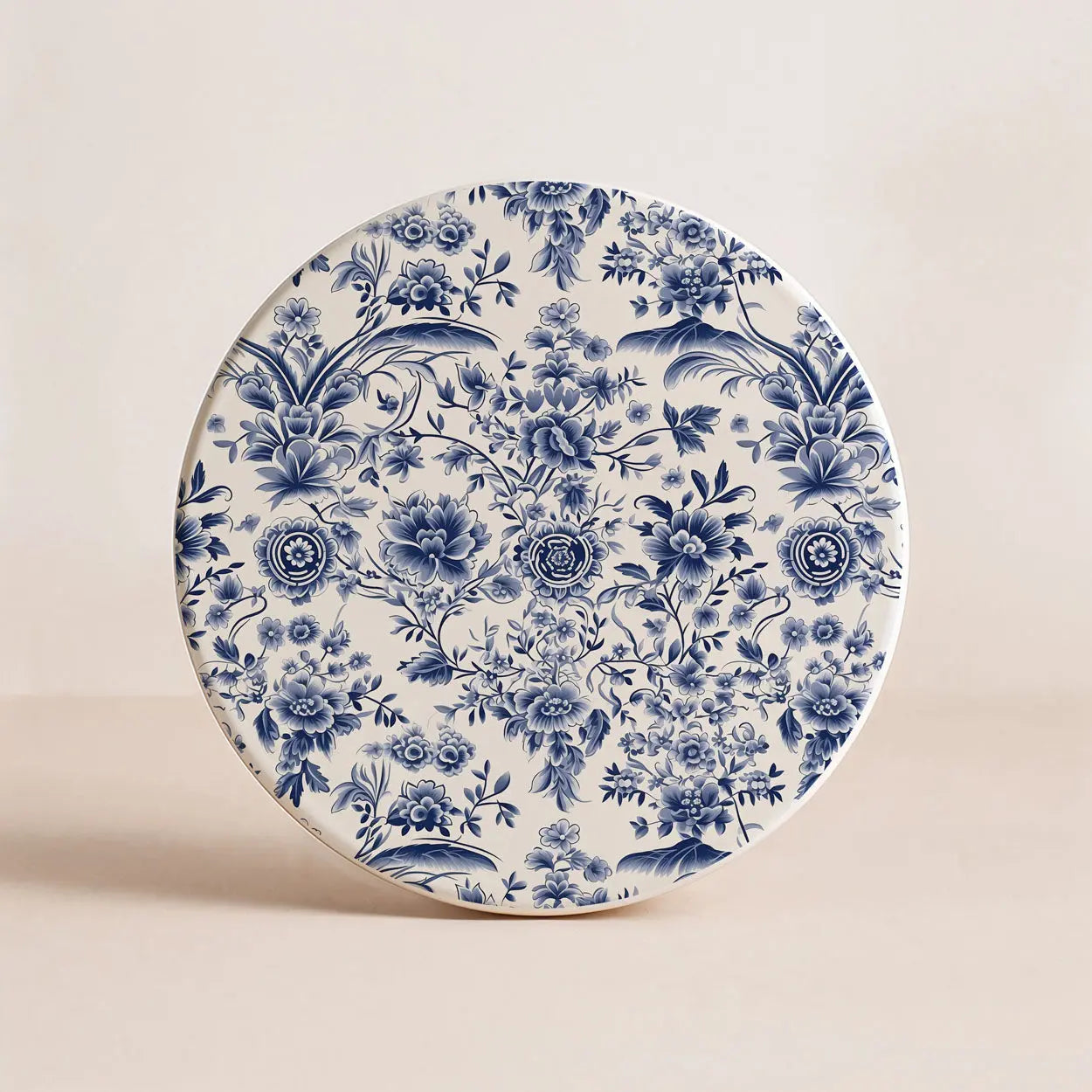 Decorative coaster with blue floral pattern on a beige background
