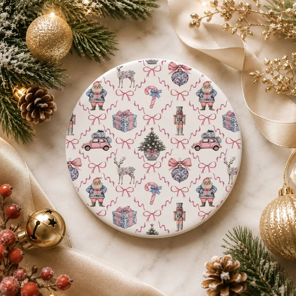 Decorative plate with Christmas-themed pattern surrounded by festive decorations on a marble surface.