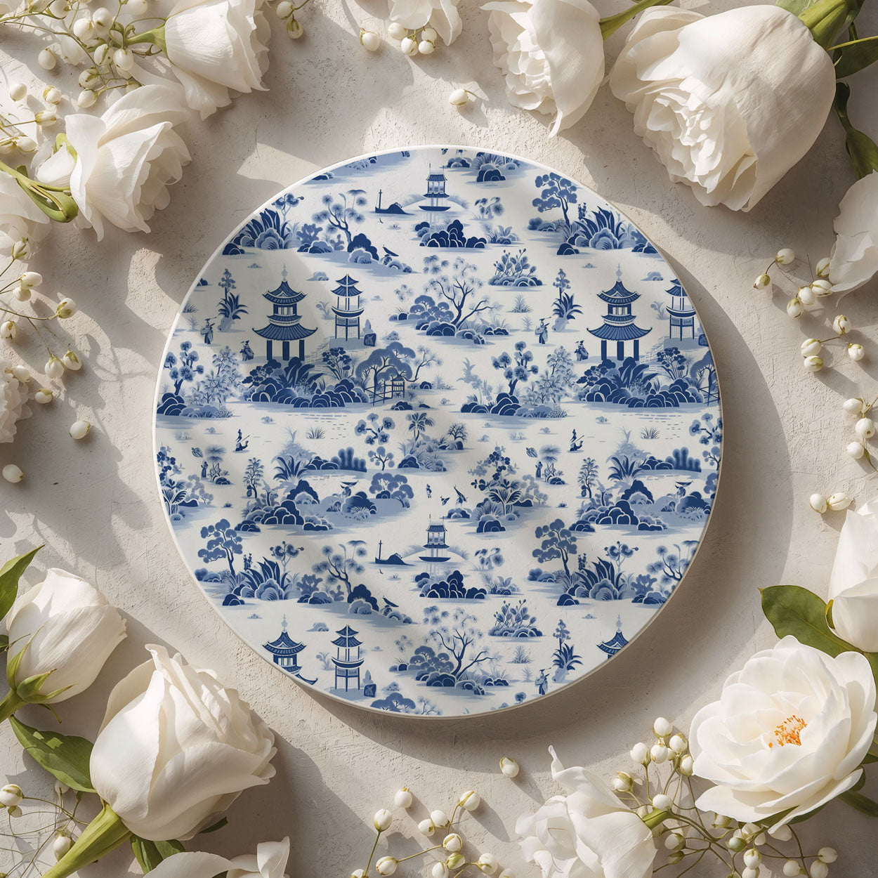 Decorative coaster with blue and white pattern surrounded by white flowers