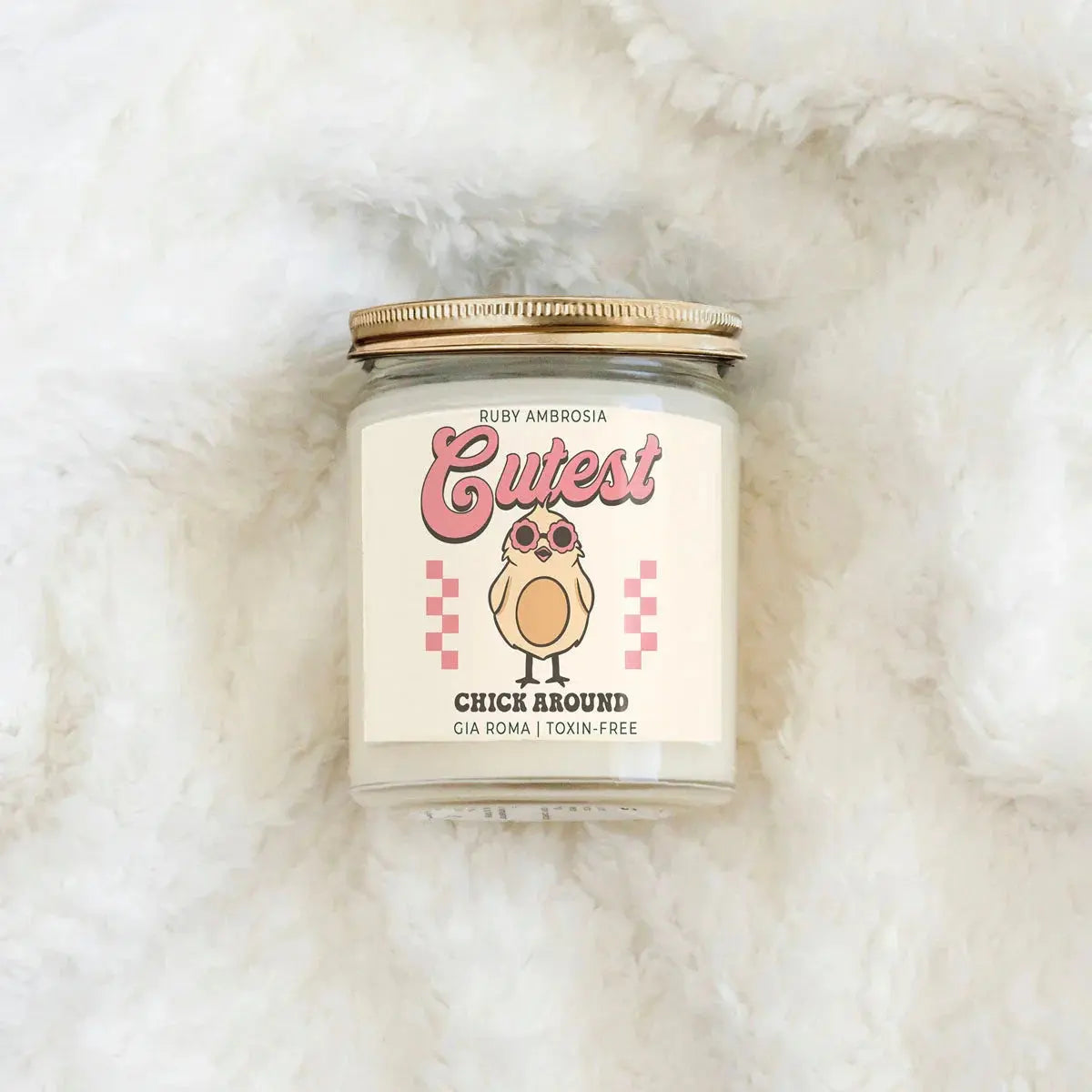 Candle jar with a cute label on a fluffy white surface