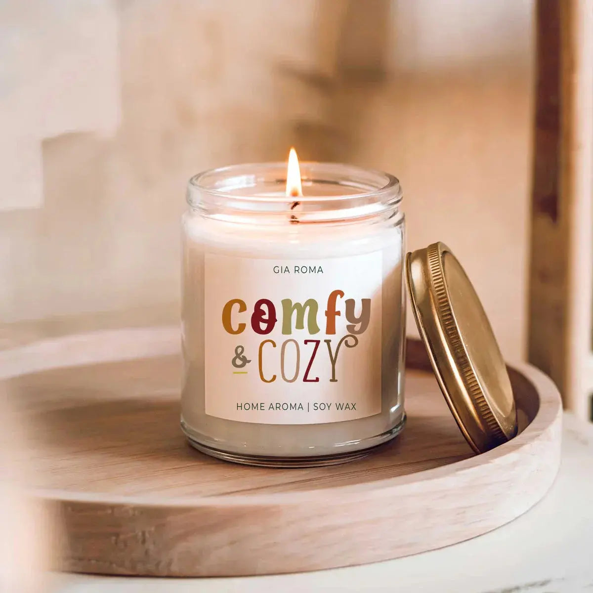 Candle in a glass jar with a colorful label on a wooden surface