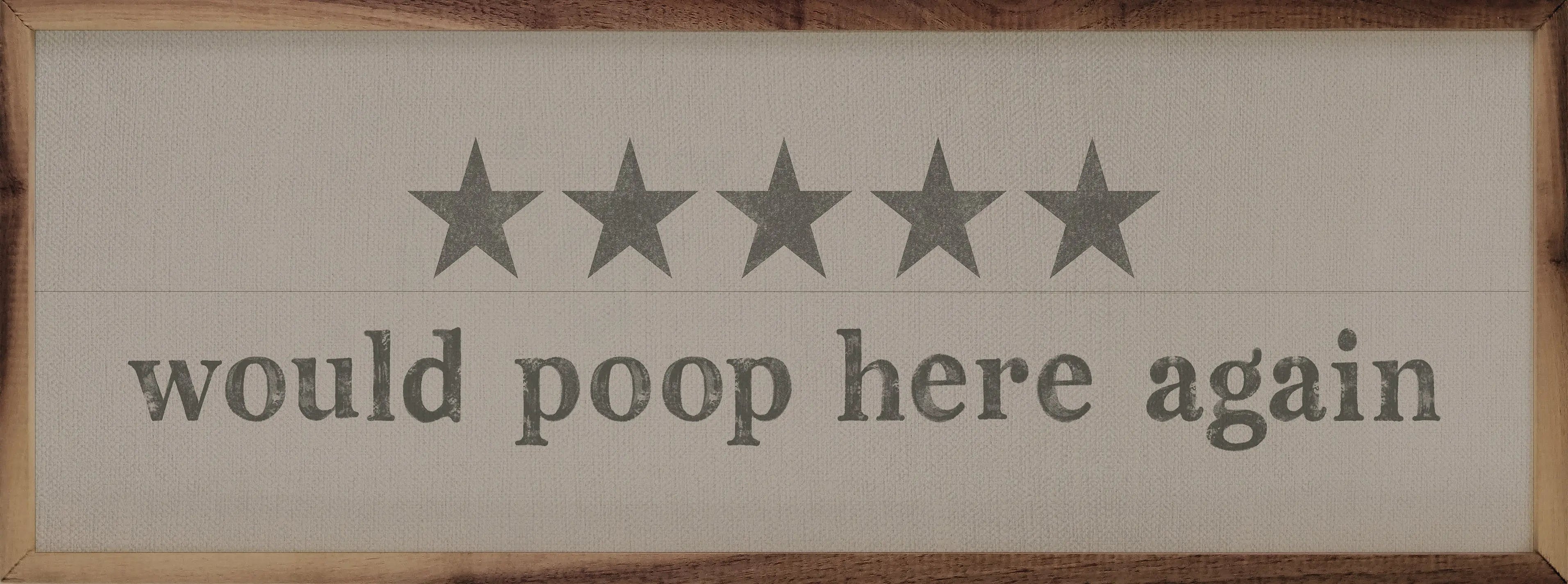 Wooden sign with five stars and text 'would poop here again' on a wooden background