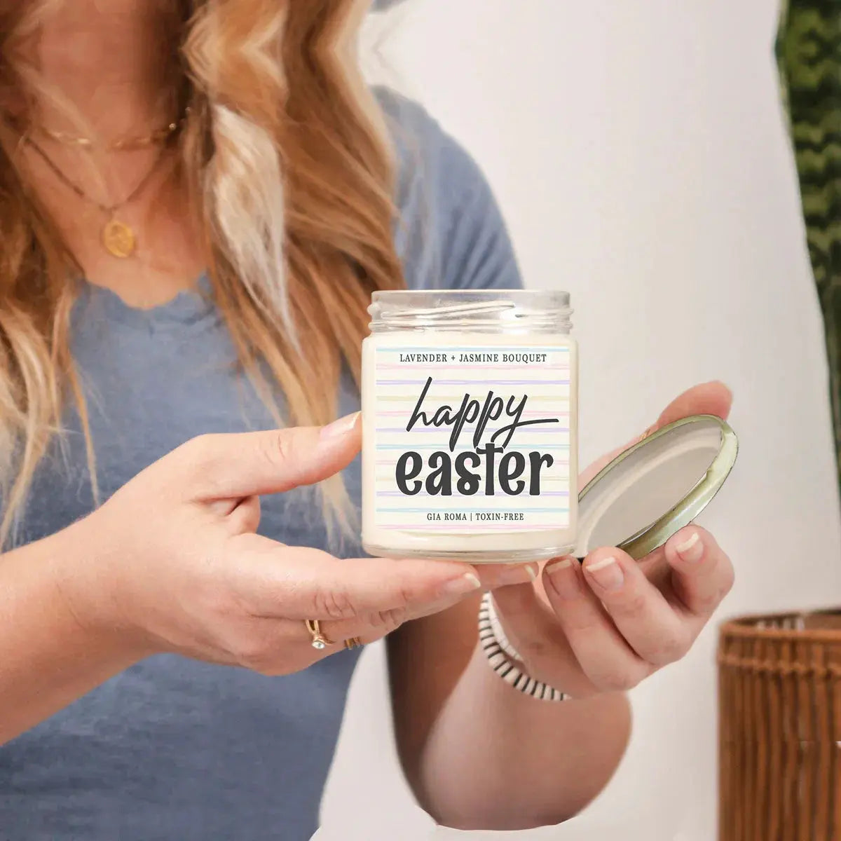 Person holding a candle labeled 'easter vibes' with a colorful label.