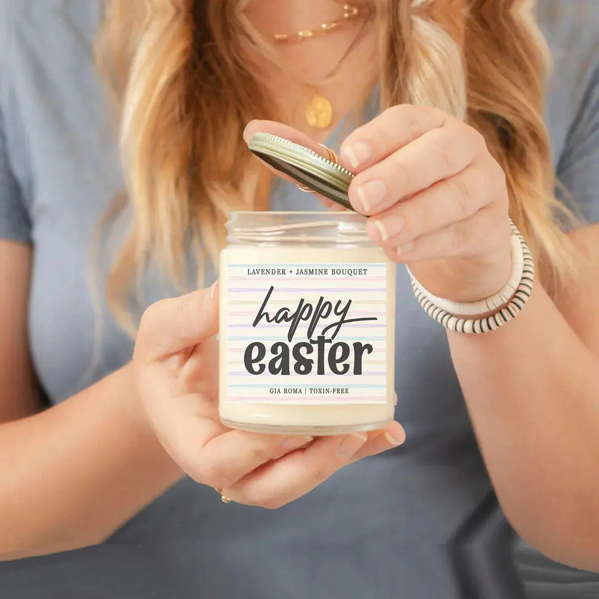 Person holding a candle labeled 'For Peeps Sake' with a neutral background