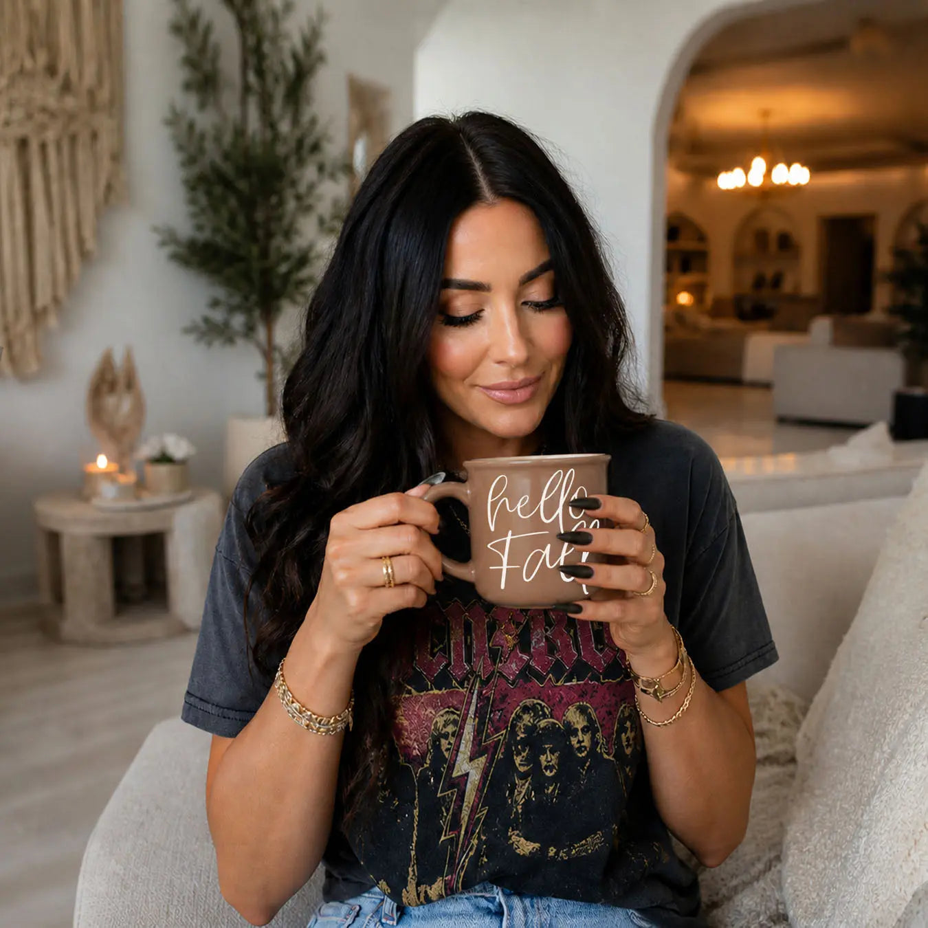 Woman holding a mug with text in a cozy living room