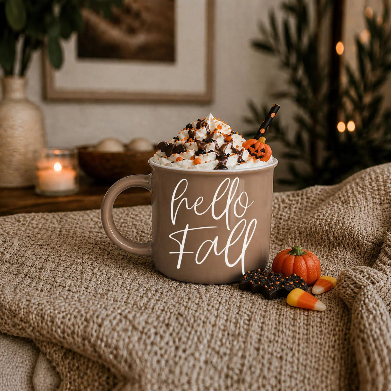 Mug with Halloween-themed coffee and decorations on a cozy blanket