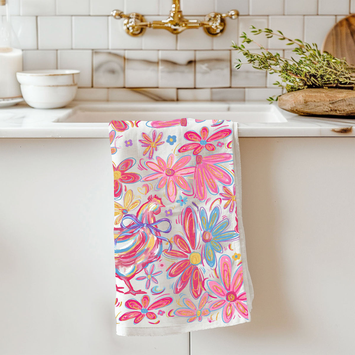 Floral patterned towel hanging on a kitchen towel rack with a kitchen background.