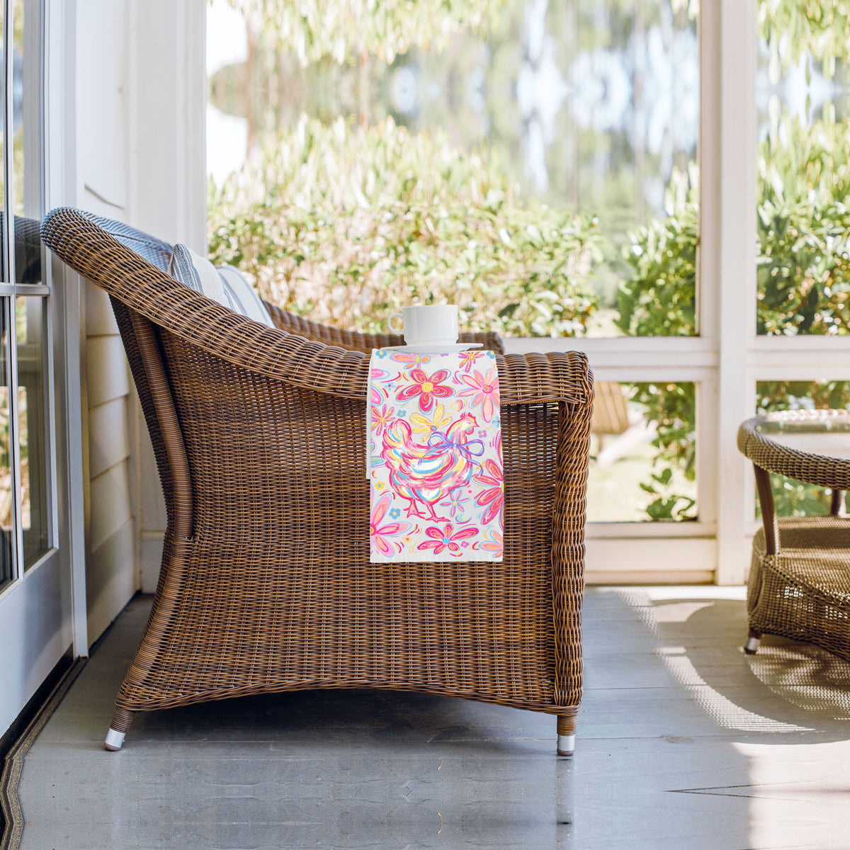 Wicker chair with a colorful towel on a porch