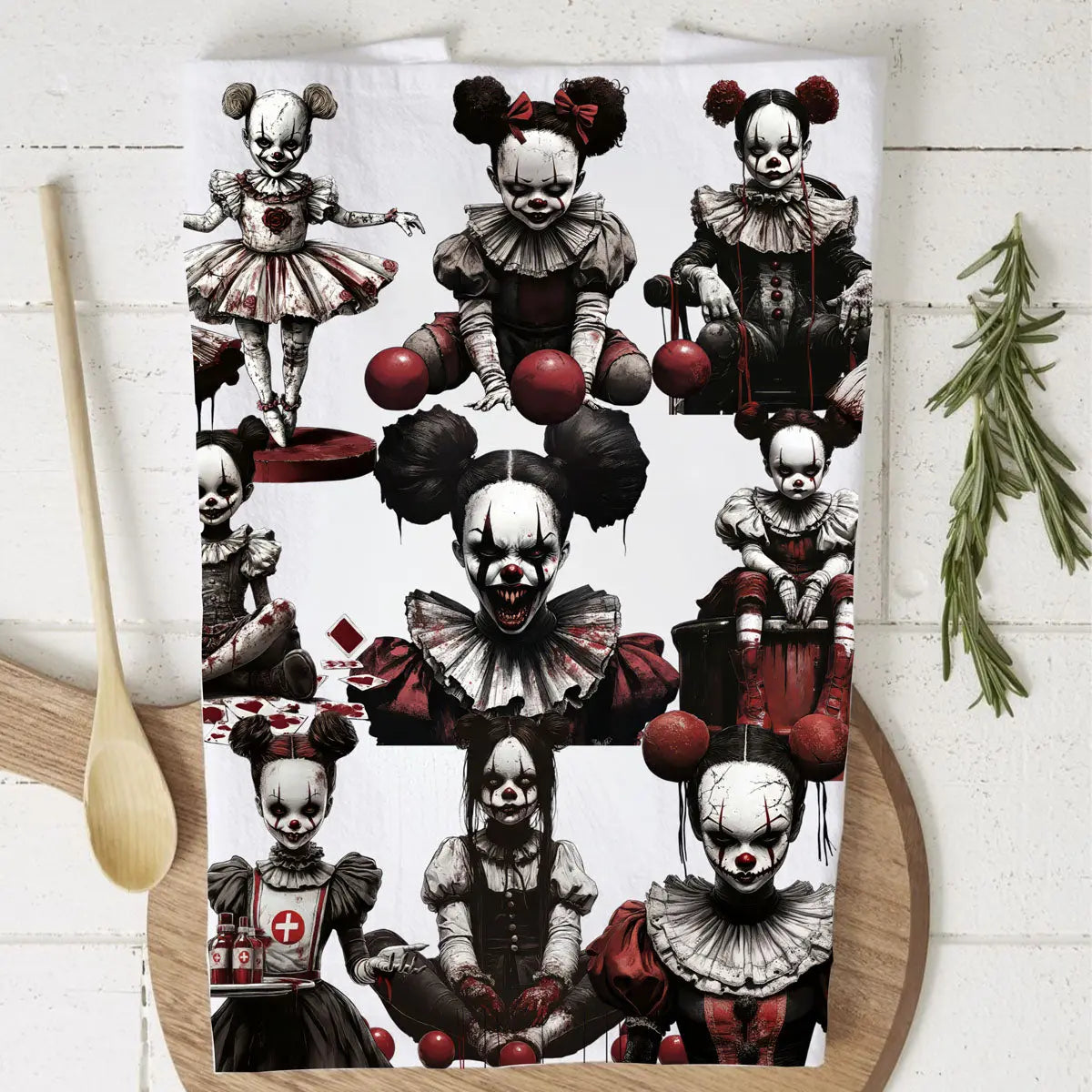 Tea towel with horror-themed clown design on a wooden board.
