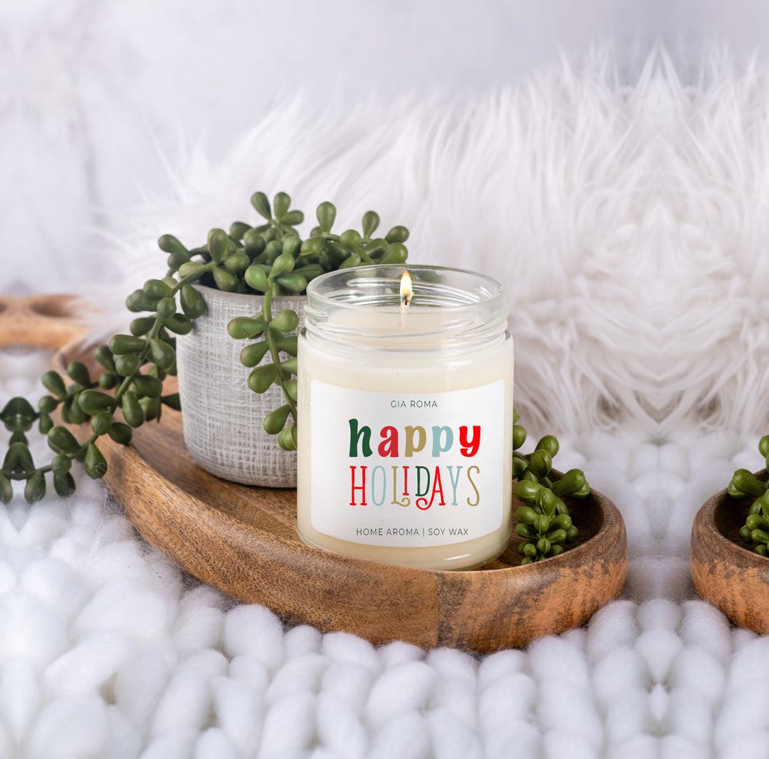 Candle with 'Happy Holidays' label on a wooden tray with plants