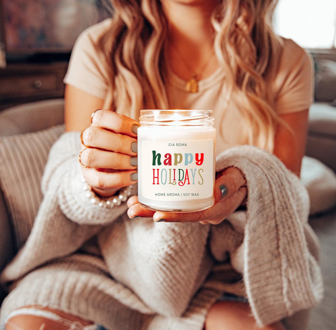 Person holding a candle labeled 'easter vibes' in a cozy indoor setting