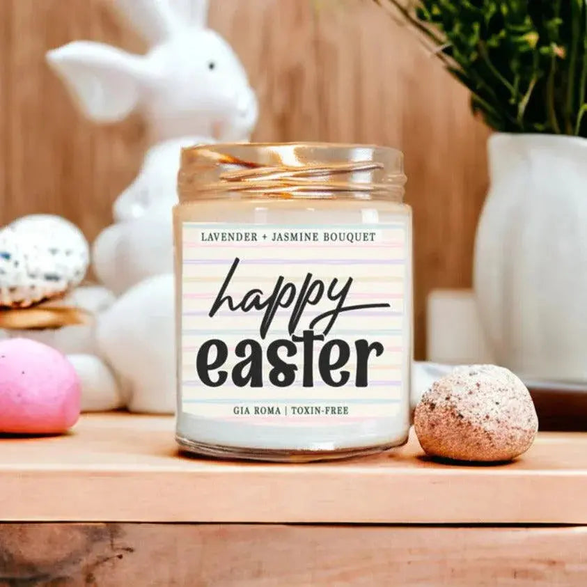 Candle with 'Happy Easter' label on a wooden surface with decorative items.