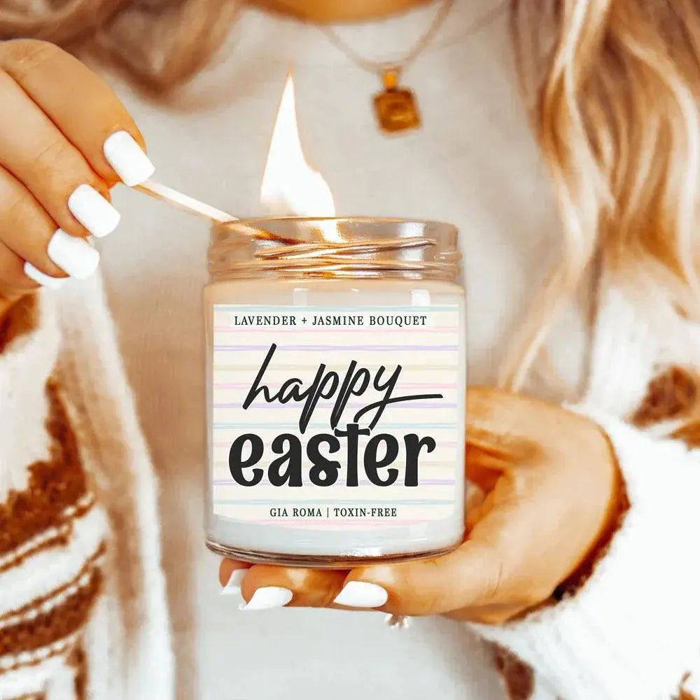 Person lighting a 'happy easter' scented candle with lavender and jasmine fragrance.