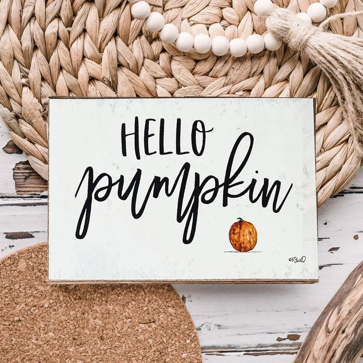 Decorative sign with 'Hello Pumpkin' text on a rustic background