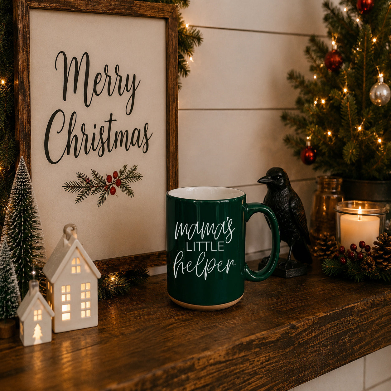 Christmas-themed decor with a mug, sign, and tree on a wooden surface.