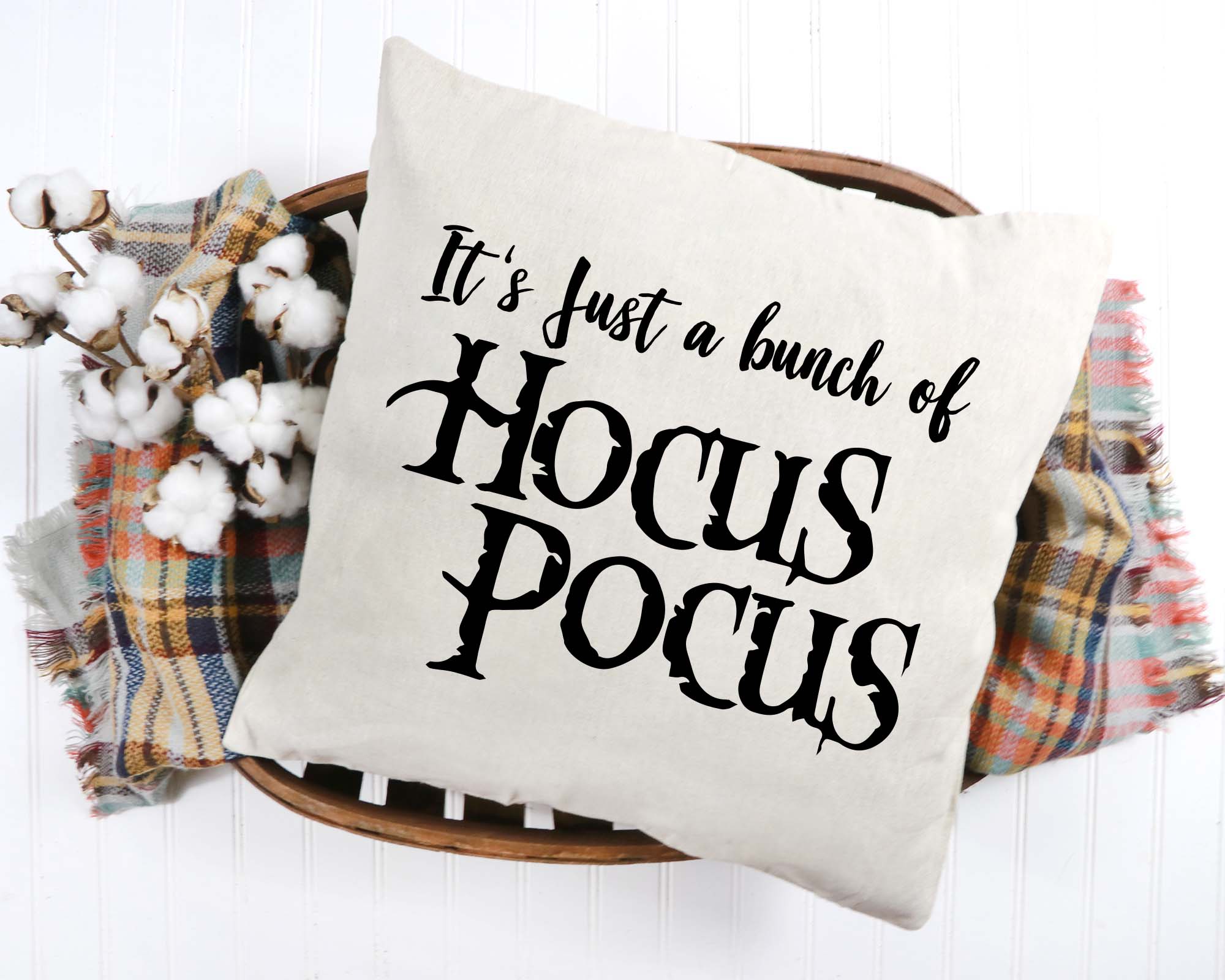 Decorative pillow with 'Hocus Pocus' text on a white background